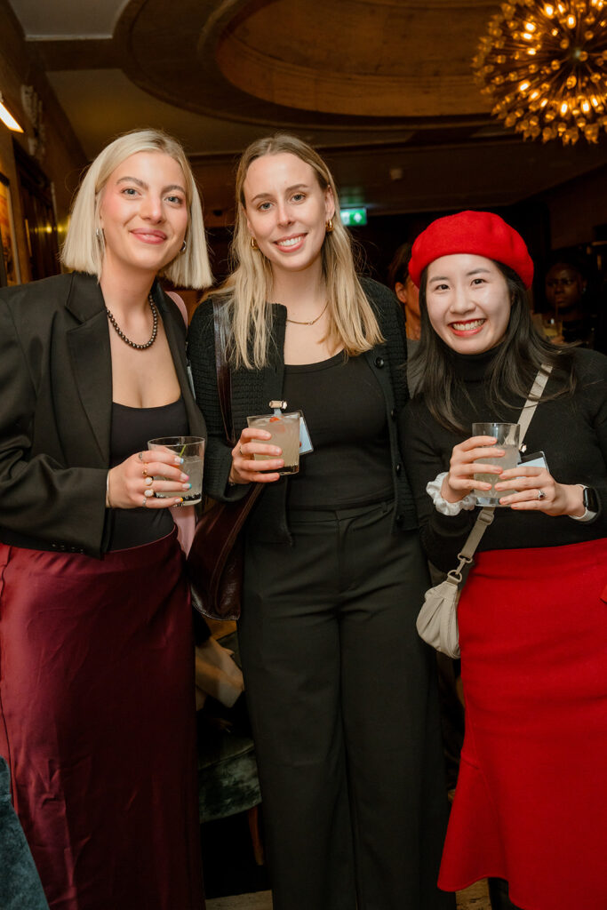 A photograph of three women smiling.