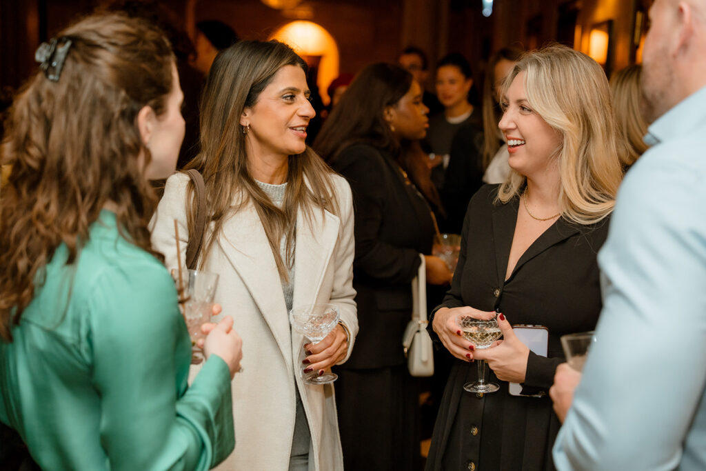 A photograph of four people talking.